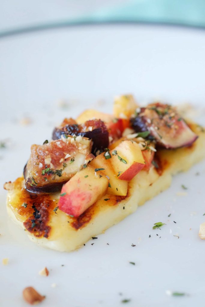 finished plate of grilled halloumi and figs with nectarines and thyme
