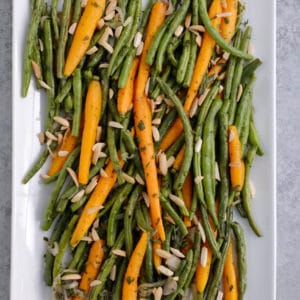 Roasted green beans and carrots on a platter
