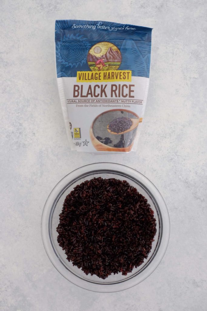 Black rice in bag and cooked black rice in bowl
