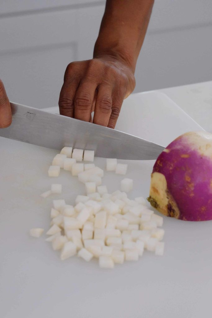 turnips being diced with a knife