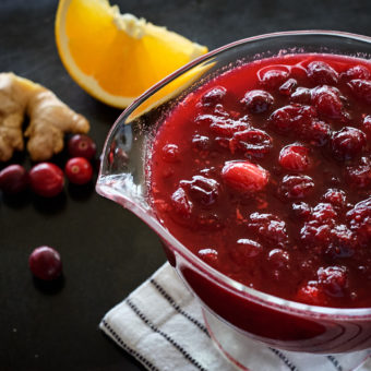 cranberry sauce in glass bowl with orange and ginger