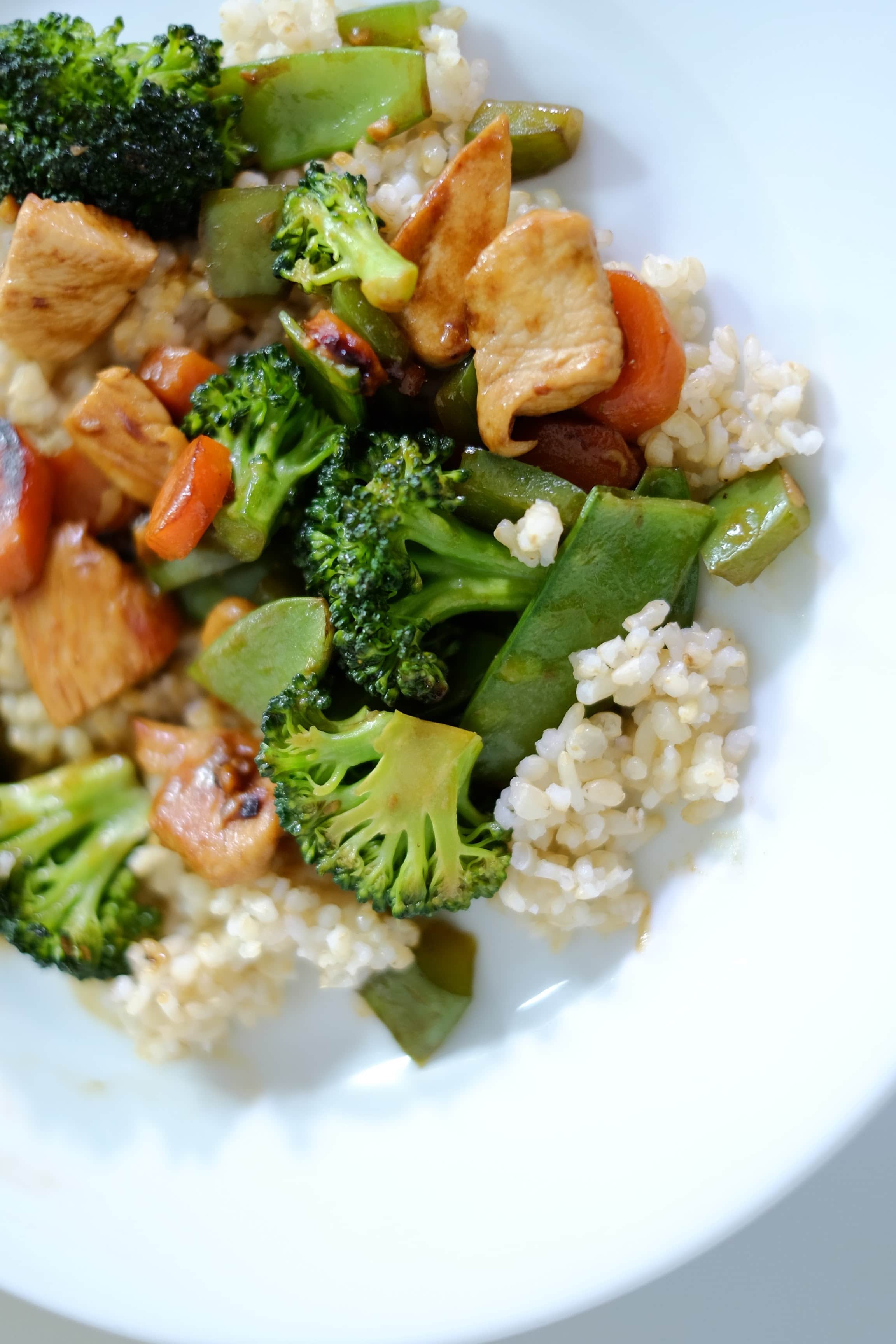 Chicken and Vegetable with brown rice on a white plate